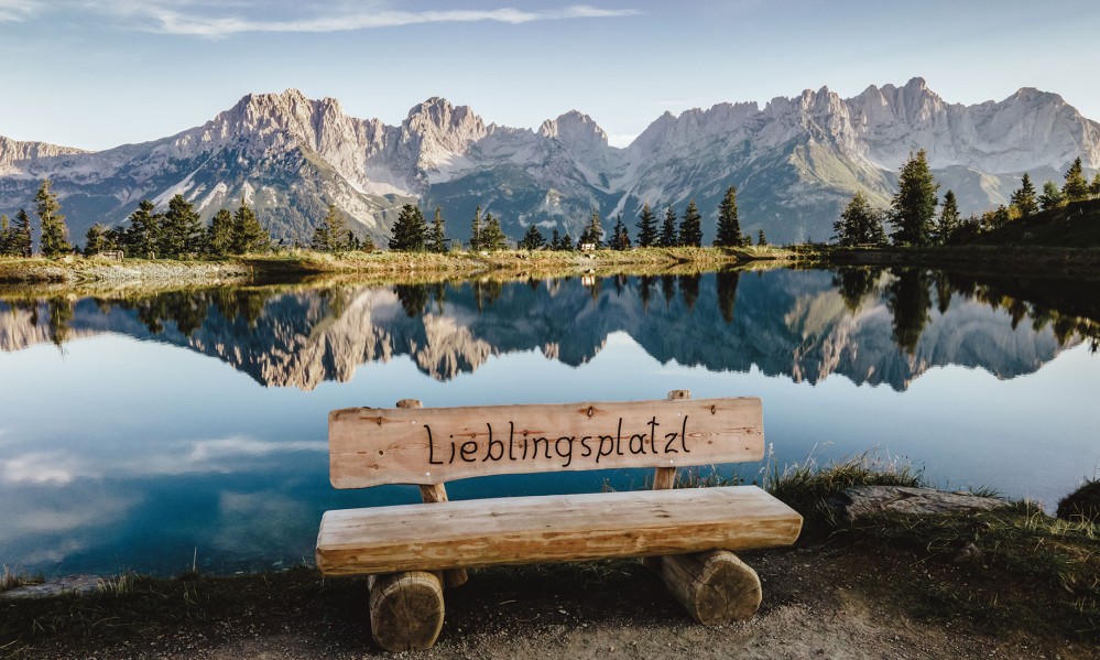 Bench with inscription, the Wilder Kaiser in the background